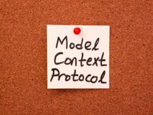 "Model Context Protocol" handwritten on a post-it note, stuck on a bulletin board